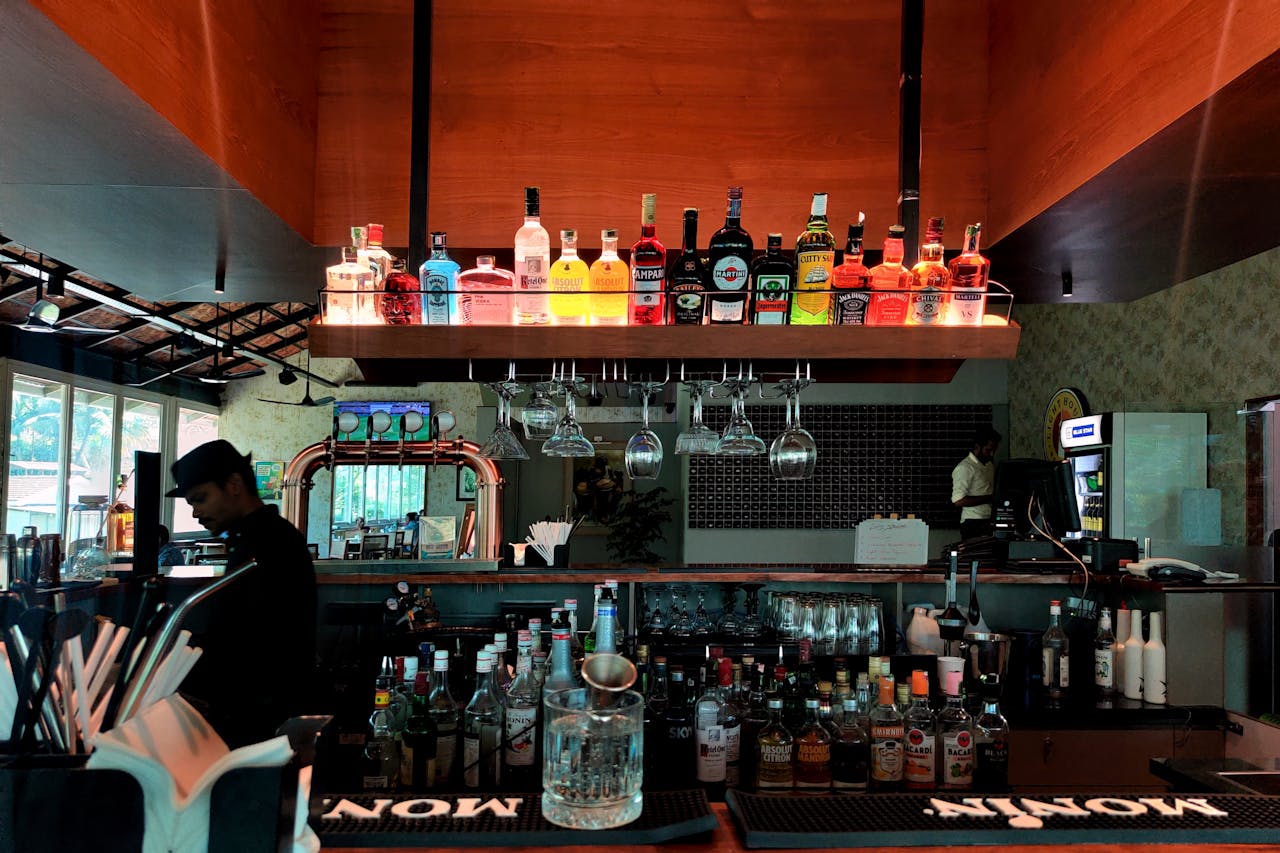 Alcohol Bottles on Shelf over Bar Counter